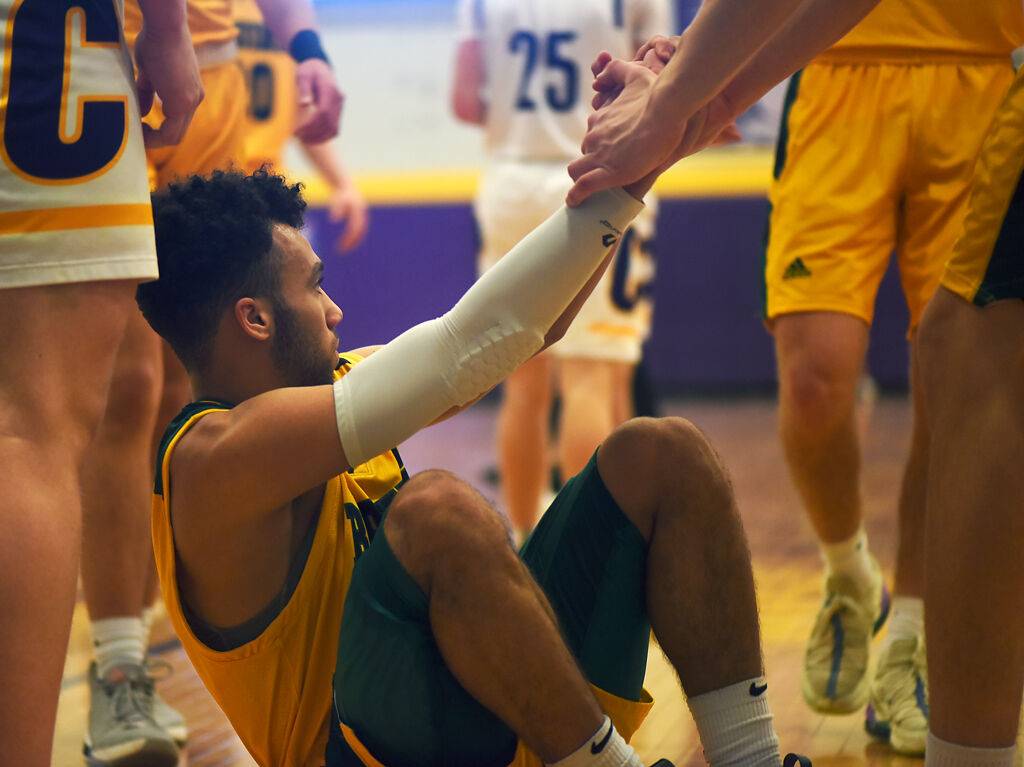 Rock Bridge teammates help Xavier Sykes off the ground